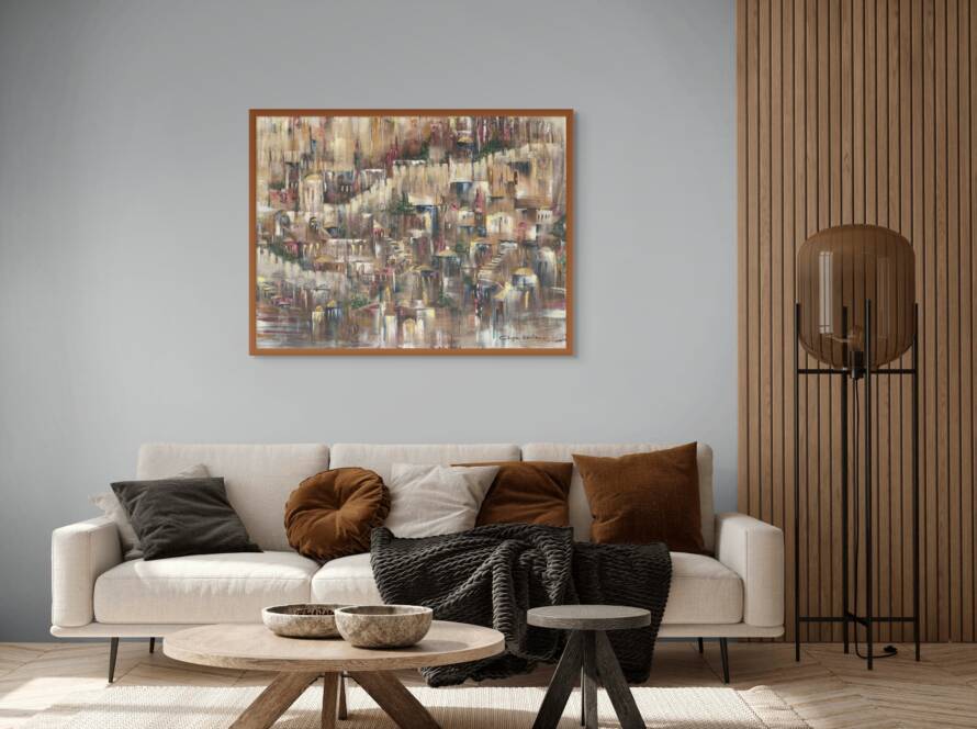 Framed artwork of Jerusalem in earthy tones, hanging above a modern white sofa with a minimal coffee table, next to a window letting in soft natural light.